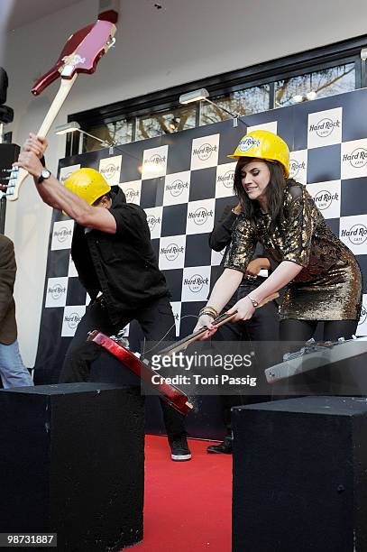 Singer 'Evil' Jared Hennagan and Amy Macdonald smash a guitar attend the re-opening of the Hard Rock Cafe on April 28, 2010 in Berlin, Germany.