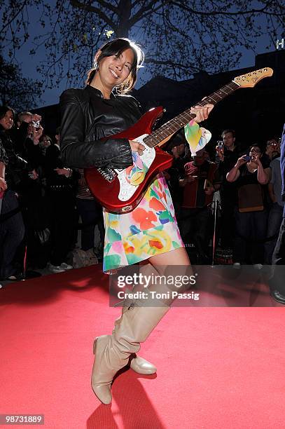 Minh-Khai Phan-Thi poses with gitare attends the re-opening of the Hard Rock Cafe on April 28, 2010 in Berlin, Germany.