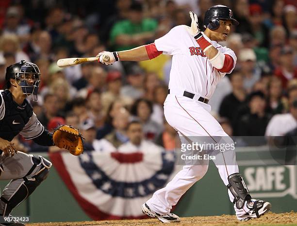 Victor Martinez of the Boston Red Sox takes a swing as Jorge Posada of the New York Yankees defends on April 4, 2010 during Opening Night at Fenway...