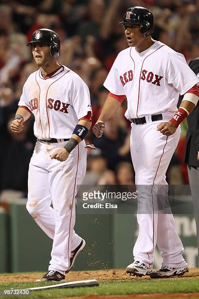 Dustin Pedroia and Victor Martinez of the Boston Red Sox celebrate after they scored against the New York Yankees on April 4, 2010 during Opening...