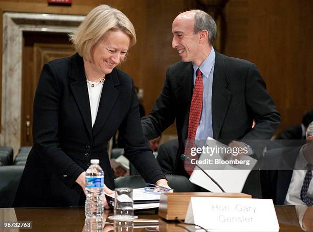 Mary Schapiro, chairman of the U.S. Securities and Exchange Commission , left, takes her seat following testimony by Gary Gensler, chairman of the...