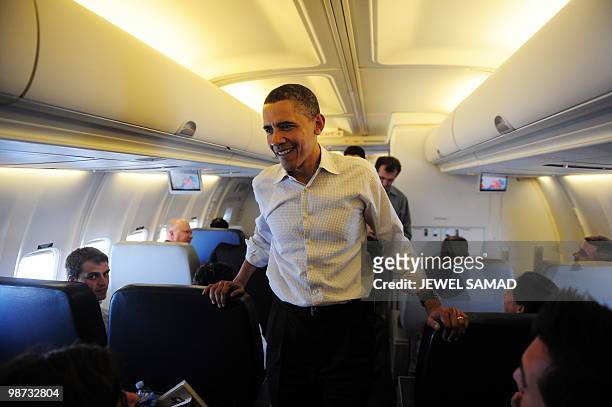 President Barack Obama speaks with traveling journalists on board Air Force One on April 28, 2010. Obama met more Americans yet to feel the nascent...