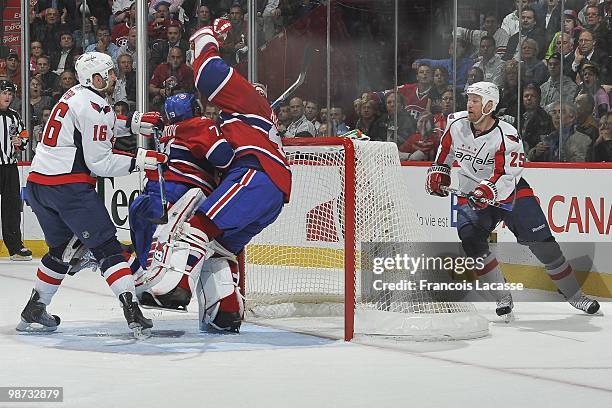 Eric Fehr of the Washington Capitals pushes Andrei Markov of Montreal Canadiens on goalie Jaroslav Halak of Montreal Canadiens in Game Six of the...