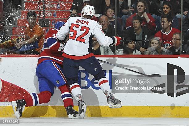 Mike Green of the Washington Capitals checks Dominic Moore of the Montreal Canadiens in Game Six of the Eastern Conference Quarterfinals during the...