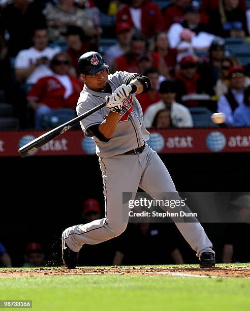 Jhonny Peralta of the Cleveland Indians hits a sacrifice fly to score Austin Kearns in the second inning against the Los Angeles Angels of Anaheim on...