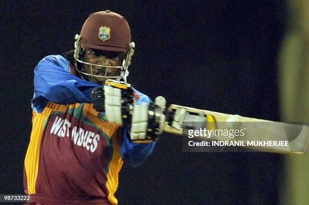 West Indies cricketer Chris Gayle plays a shot during the warm-up match between West Indies and New Zealand at the Providence Stadium in Guyana on...