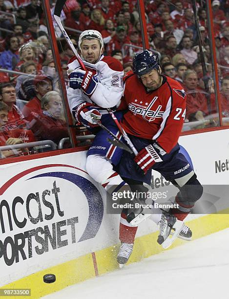 Josh Gorges of the Montreal Canadiens is hit into the boards by Scott Walker of the Washington Capitals in Game Seven of the Eastern Conference...