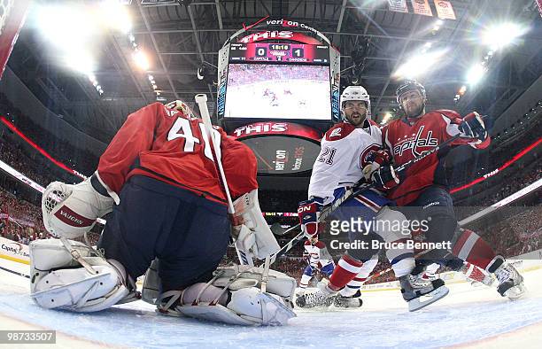 Brian Gionta of the Montreal Canadiens is stopped by Mike Green and goaltender Semyon Varlamov of the Washington Capitals in Game Seven of the...