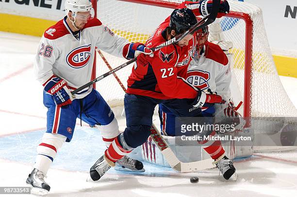 Mike Knuble of the Washington Capitals fights for loose puck against Josh Gorges of the Montreal Canadiens during Game Seven of the Eastern...