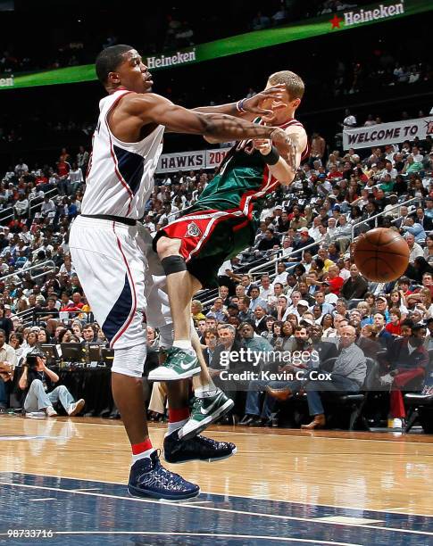 Luke Ridnour of the Milwaukee Bucks is fouled hard by Joe Johnson of the Atlanta Hawks during Game Five of the Eastern Conference Quarterfinals of...