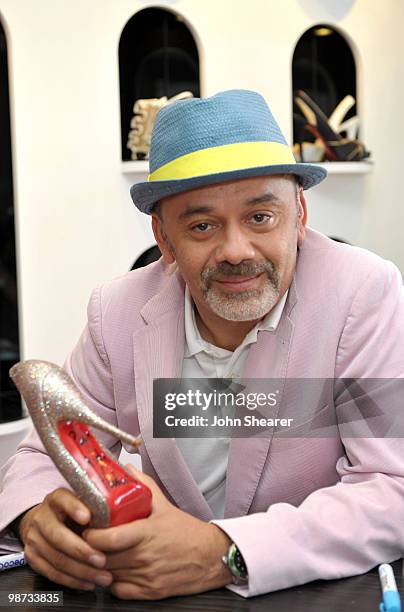 Designer Christian Louboutin signs shoes at the Christian Louboutin Boutique on April 28, 2010 in West Hollywood, California.