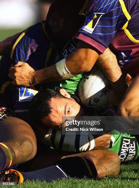 Jason Croker for the Raiders looks for a way though the Broncos line during the NRL match today between the Canberra Raiders and the Brisbane Broncos...