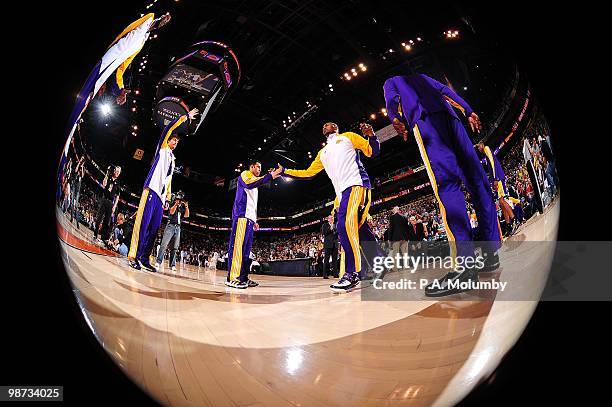 Ron Artest slaps hands with Jordan Farmar of the Los Angeles Lakers during pre-game introductions before the game against the Phoenix Suns on March...