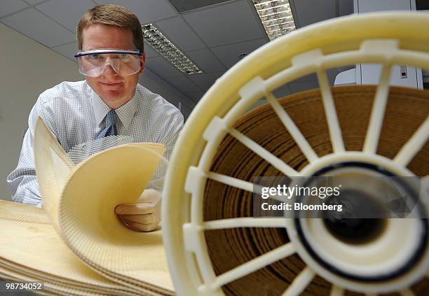 Kevin Cassidy, Asia-Pacific general manager of GE Water & Process Technologies, poses for a photograph with reverse osmosis membranes at the NUS-GE...