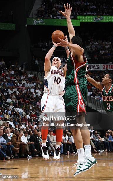 Mike Bibby of the Atlanta Hawks puts up a shot against Dan Gadzuric of the Milwaukee Bucks in Game Five of the Eastern Conference Quarterfinals...