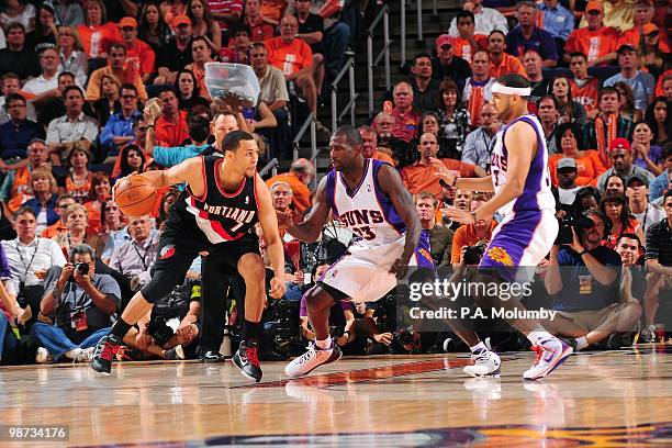 Brandon Roy of the Portland Trail Blazers moves the ball against Jason Richardson and Jared Dudley of the Phoenix Suns during Game Five of the...