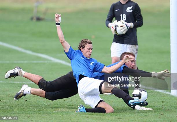 Aaron Scott and goalkeeper Mark Paston of the New Zealand All Whites compete for the ball during an All Whites training session at North Harbour...