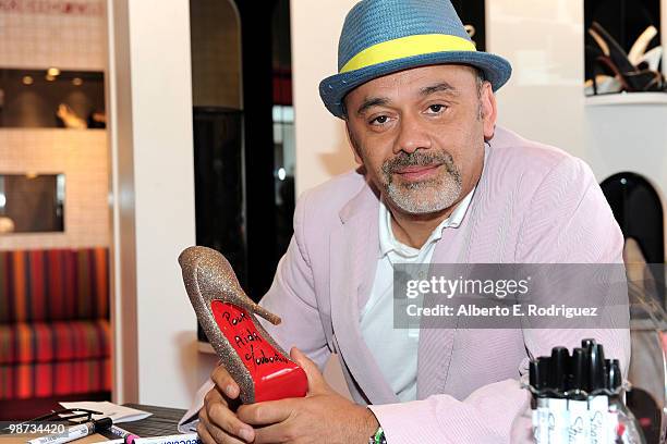 Designer Christian Louboutin signs an autograph at the grand opening of the new Christian Louboutin boutique on April 28, 2010 in West Hollywood,...