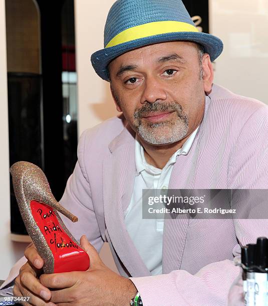 Designer Christian Louboutin poses for a photo at the grand opening of the new Christian Louboutin boutique on April 28, 2010 in West Hollywood,...