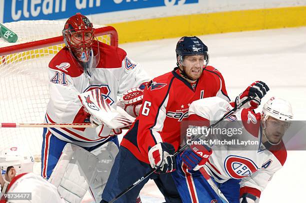 Eric Fehr of the Washington Capitals fightts for space against Andrei Markov and Jarolsav Halak of the the Montreal Canadiens during Game Seven of...