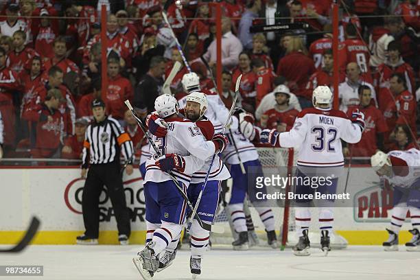 Michael Cammalleri and Glen Metropolit of the Montreal Canadiens embrace following their series winning 2-1 victory over the Washington Capitals in...