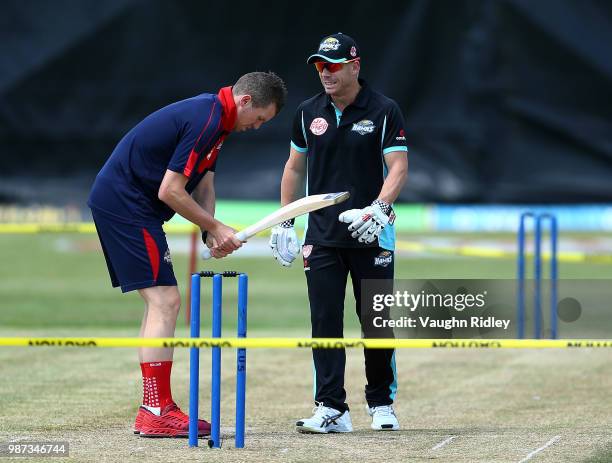 Peter Siddle of Montreal Tigers and David Warner of Winnipeg Hawks warms up prior to a Global T20 Canada match at Maple Leaf Cricket Club on June 29,...