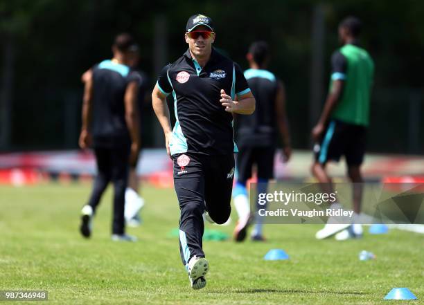 David Warner of Winnipeg Hawks warms up prior to a Global T20 Canada match against Montreal Tigers at Maple Leaf Cricket Club on June 29, 2018 in...