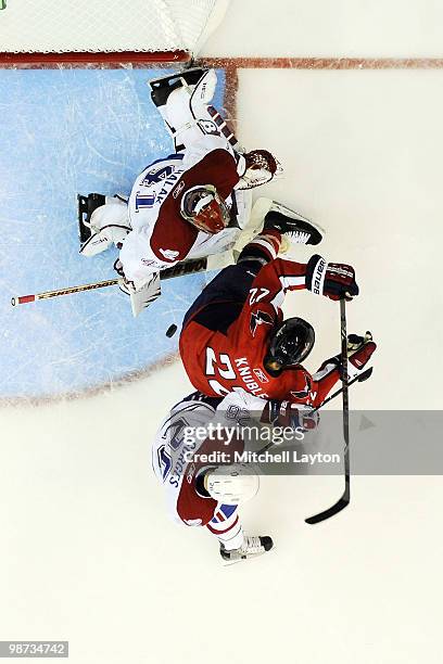 Jaroslav Halak of the Montreal Canadiens makes a save on Mike Knuble of the Washington Capitals shot during Game Seven of the Eastern Conference...