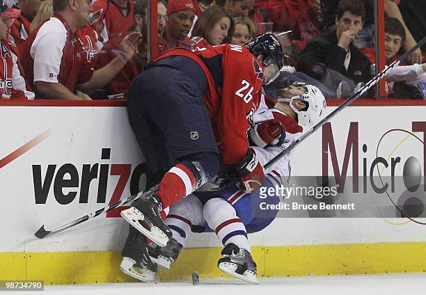 Brian Gionta of the Montreal Canadiens is hit by Shaone Morrisonn of the Washington Capitals in Game Seven of the Eastern Conference Quarterfinals...