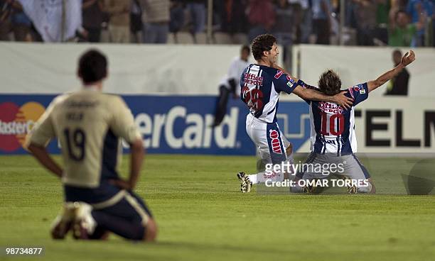 Javier Munoz and Edgar Benitez of Mexican Pachuca celebrate their victory in front of Alejandro Vela of Mexican Cruz Azul at the end of the CONCACAF...