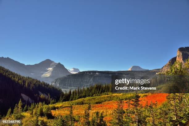a look across the mountains, valleys, and grassy meadows at piegan pass - piegan stock pictures, royalty-free photos & images