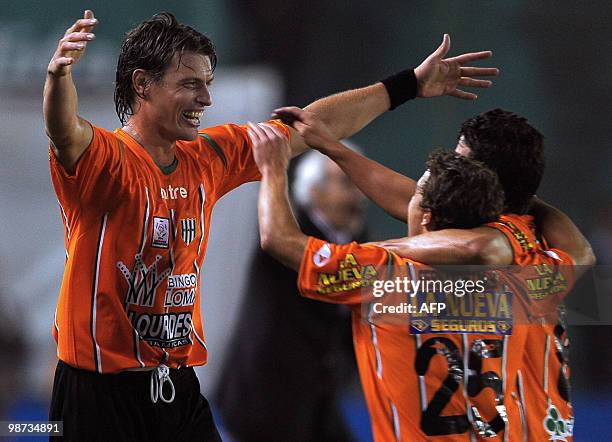 Argentina's Banfield midfielder Roberto Battion celebrates celebrates with his teammates midfielder James Rodriguez and forward Sebastian Fernandez...