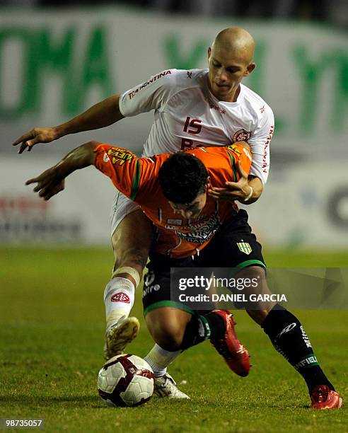 Argentina's Banfield midfielder James Rodriguez vies for the ball with Brazil's Internacional defender Nei during their round before the...