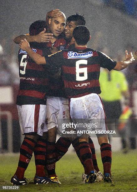 Flamengo's striker Adriano is hugged by teammates after scoring against Corinthians, on April 28, 2010 during their Libertadores Cup football match...