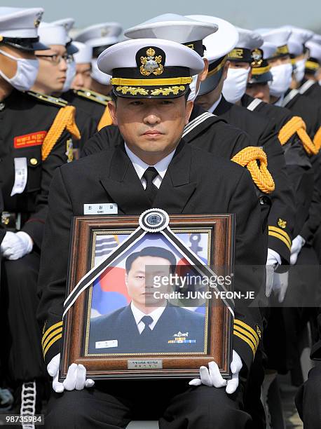 Choi Won-Il , captain of the sunken South Korean naval ship Cheonan, holds a portrait of one of the 46 sailors who died in the incident during a...