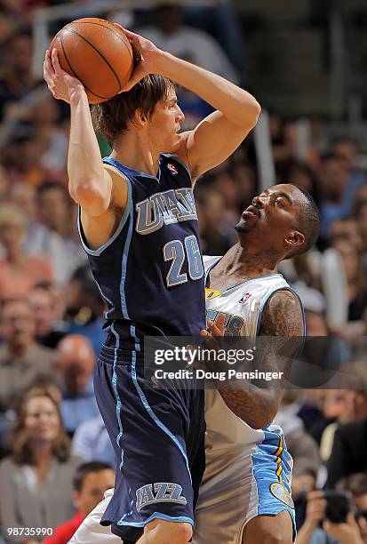 Kyle Korver of the Utah Jazz controls the ball against the defense of J.R. Smith of the Denver Nuggets in Game Five of the Western Conference...