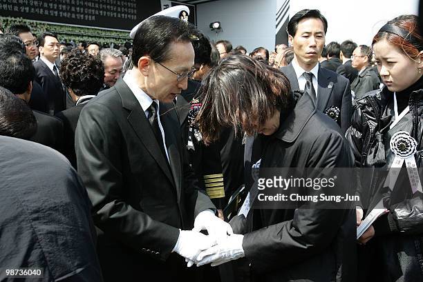 South Korean President Lee Myung-Bak consoles relatives of a deceased sailor of the sunken South Korean naval vessel Cheonan during the funeral...