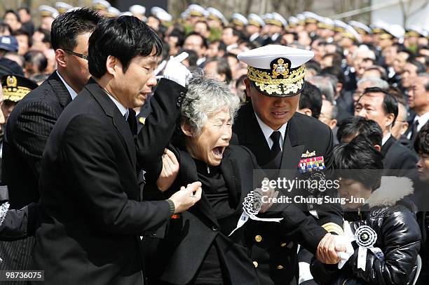 Relatives of a deceased sailor of the sunken South Korean naval vessel Cheonan weep during the funeral ceremony at the Second Fleet Command of Navy...