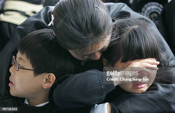 Relatives of a deceased sailor of the sunken South Korean naval vessel Cheonan weep during the funeral ceremony at the Second Fleet Command of Navy...