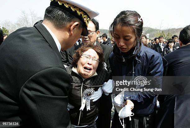 Relatives of a deceased sailor of the sunken South Korean naval vessel Cheonan weep during the funeral ceremony at the Second Fleet Command of Navy...