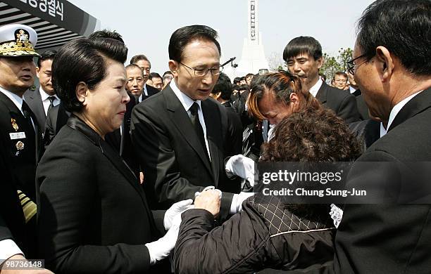 South Korean President Lee Myung-Bak and his wife Kim Yoon-ok console relatives of a deceased sailor of the sunken South Korean naval vessel Cheonan...