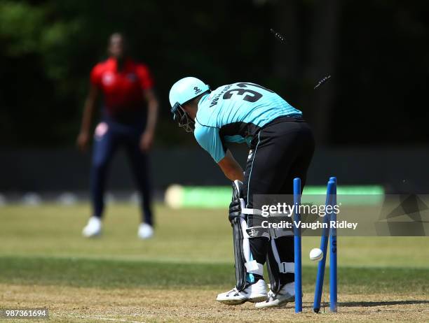 David Warner of Winnipeg Hawks is bowled by Lasith Malinga of Montreal Tigers during a Global T20 Canada match at Maple Leaf Cricket Club on June 29,...