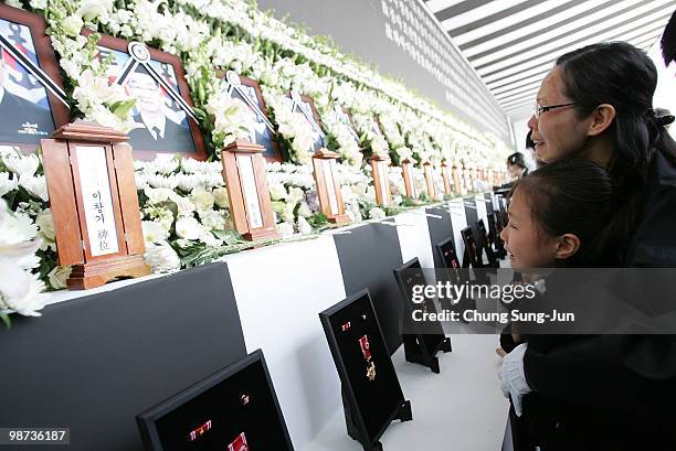 Relatives of a deceased sailor of the sunken South Korean naval vessel Cheonan weep during the funeral ceremony at the Second Fleet Command of Navy...