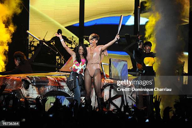 Singer Rihanna invites a fan on stage at Palais Omnisports de Bercy on April 28, 2010 in Paris, France.