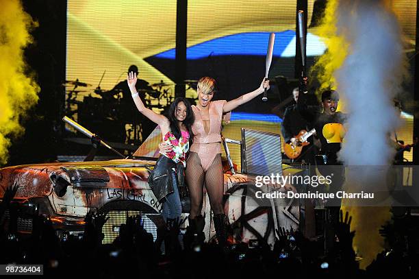 Singer Rihanna invites a fan on stage at Palais Omnisports de Bercy on April 28, 2010 in Paris, France.