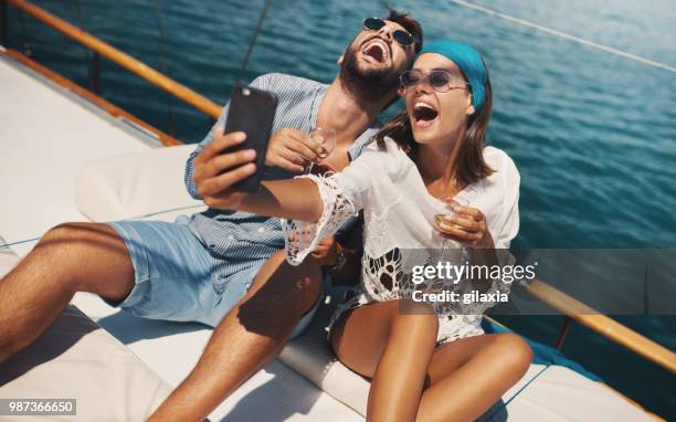 couple on a sailboat. - gilaxia stock pictures, royalty-free photos & images