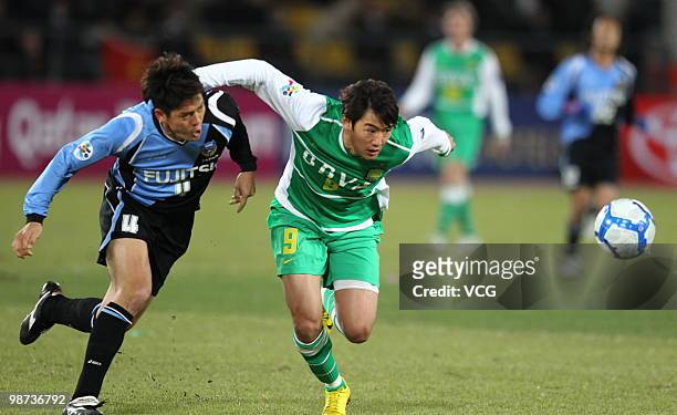 Yusuke Igawa of Kawasaki Frontale fights for a ball with Wenhui Du of Beijing Guoan during the AFC Champions League Group E match between Beijing...