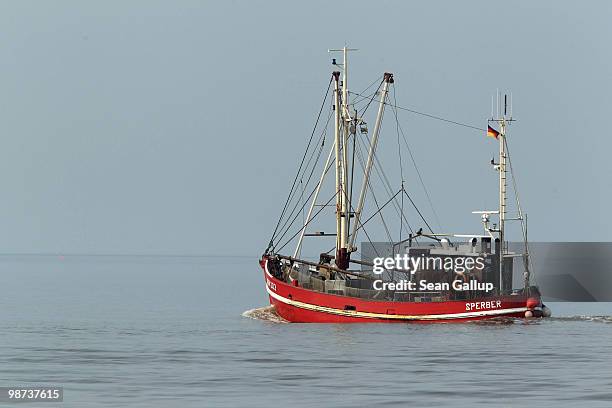 Fishing boat heads out to sea near the island of Juist in the North Sea on April 28, 2010 near Norddeich, Germany. Frisia and the Frisian coast are a...