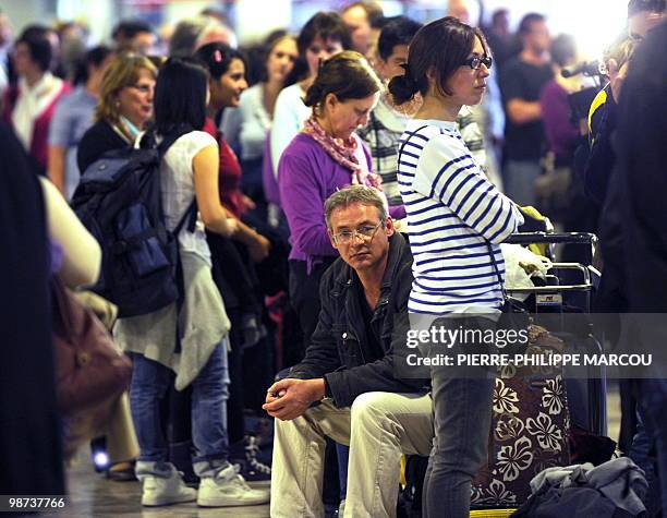 Passengers queue and wait inside Madrid's Barajas airport on April 16, 2010 in Madrid. A huge cloud of volcanic ash from Iceland cast a growing...