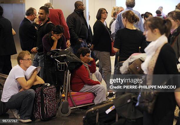 Passengers queue and wait inside Madrid's Barajas airport on April 16, 2010. A huge cloud of volcanic ash from Iceland cast a growing shadow over...